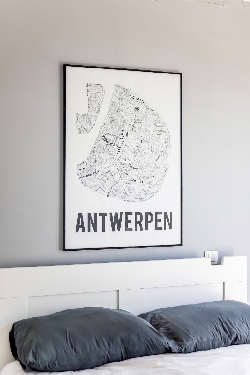 Bedroom with Antwerp poster and city view